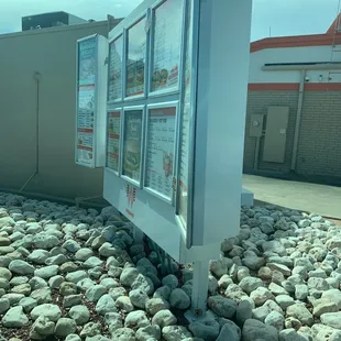 a picture of a building with rocks surrounding it