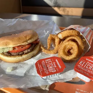 a hamburger and onion rings