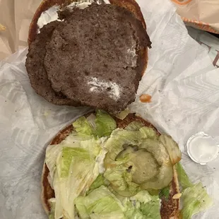 a hamburger with lettuce and cheese