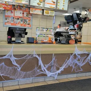 a restaurant with a spider web covering the counter