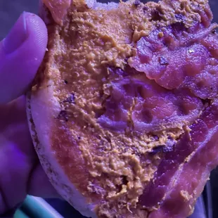 a hand holding a half eaten pizza