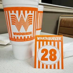 a cup of coffee and a sign