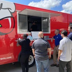 people ordering food from a food truck