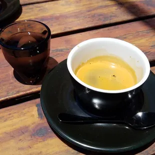 Espresso served as double shot, with sparkling water