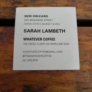 a business card on a wooden table