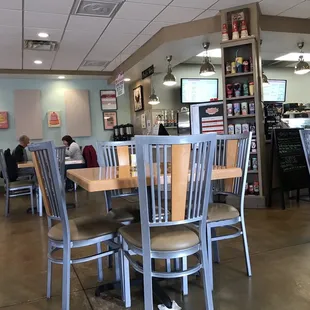 Very nice dining room with tables and chairs. Very warm, super clean, and inviting.