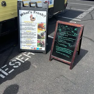 a sign and a food truck