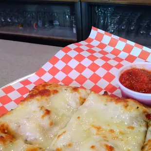 Cheesy flatbread sauce on the side.