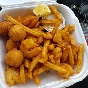 Shrimp basket and fries and hush puppies the bomb