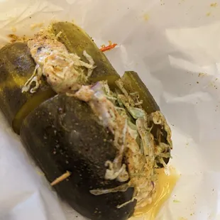 a pickle with shredded cheese