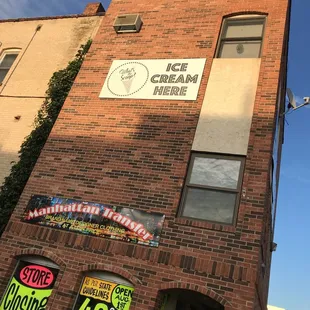 a brick building with signs on it