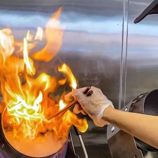 a person cooking in a wok