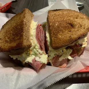 a ham and cheese sandwich in a basket