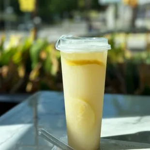 a drink in a plastic cup on a table