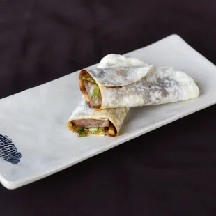 two burritos on a white plate