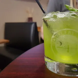a green drink with a straw