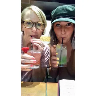 two women drinking a drink