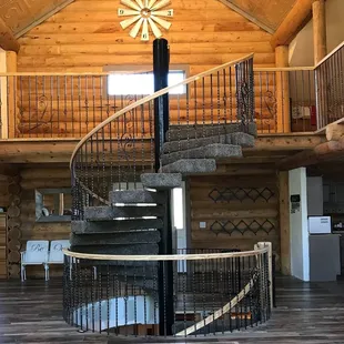 New log home construction in 2015 with spiral staircase centered through 3 floors.