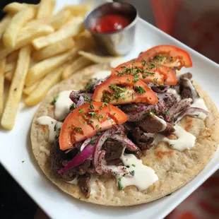 a steak taco and french fries
