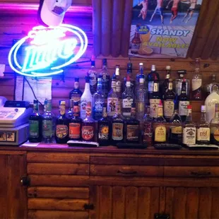a bar with a lot of liquor bottles