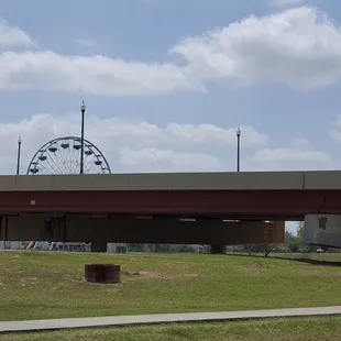 Overpass, path, and Ferris wheel from the park&apos;s parking lot