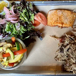 Salad, salmon, grilled vegetables, and pulled pork