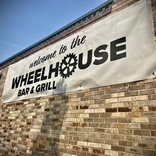 a sign on the side of a brick building