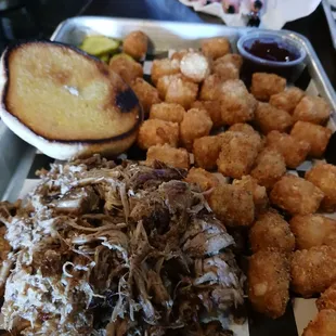 Pulled pork sandwich, bbq sauce on side with tator tots
