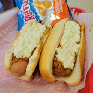 two hotdogs in buns on a red tray