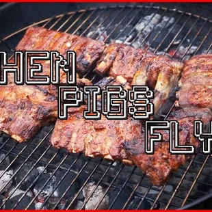 a barbecue grill with meat on it