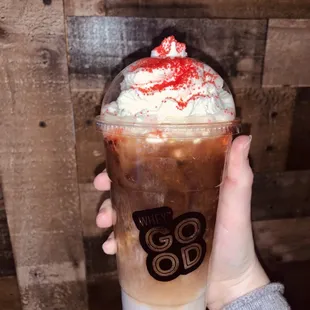 a hand holding a cup of coffee