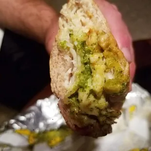 a hand holding a sandwich