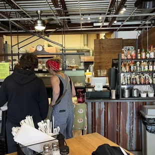 two people standing at the counter