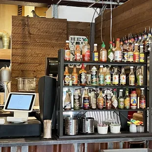 a counter with a lot of bottles on it