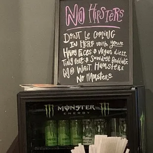 a mini fridge and a sign