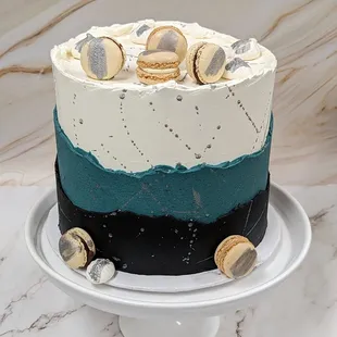 Extra Tall 8" Layered Buttercream Cake, accented with Macarons.