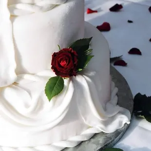 Fondant cake with fondant swag and simple flower accent.