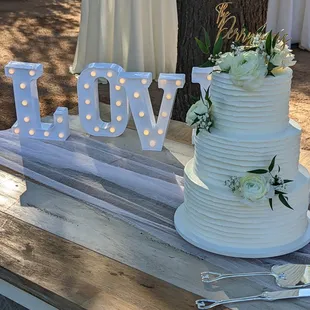 Buttercream ribbon design, accented with fresh flowers.
