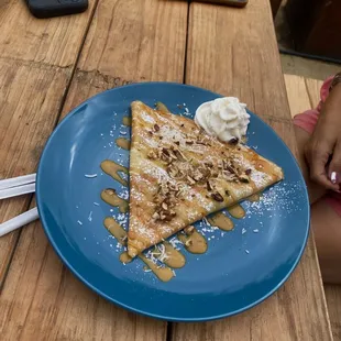 Crepe with dulce de leche, pecan, coconut, and whipped cream.