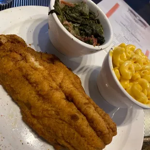 Fried catfish dinner with macaroni and cheese and greens.