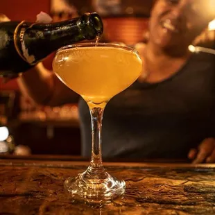 a woman pouring a drink