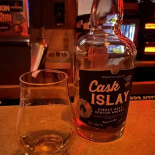 a glass and bottle of cask island rum