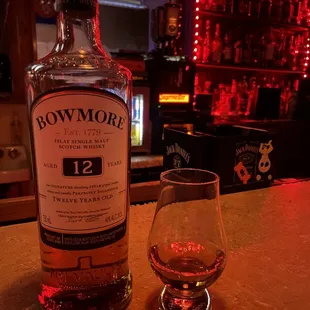 a bottle of bowmore 12 years old and a glass of brandy