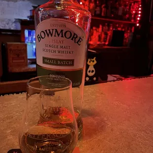 a bottle of bowmore single malt irish whiskey and a glass