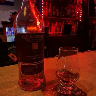 a bottle and a glass on a bar