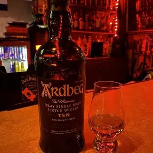 a bottle and a glass on a bar