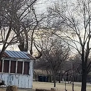 an old red truck parked in a field