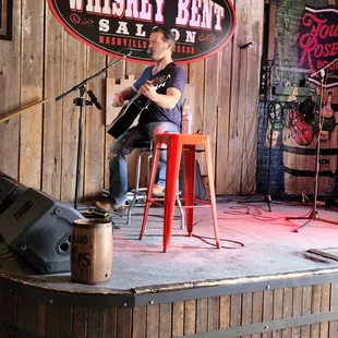 a man playing guitar on stage