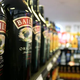 a row of bottles in a liquor store