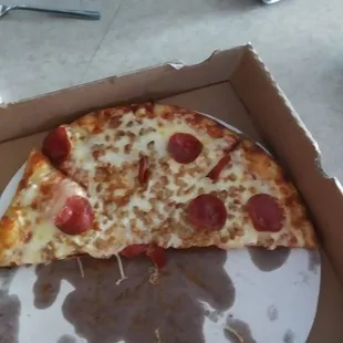 Sausage and pepperoni  pizza  with the crumbled sausage.